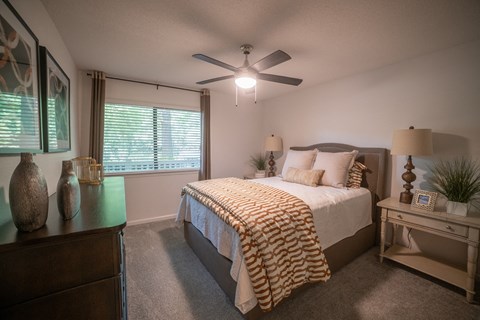 a bedroom with a large bed and a ceiling fan